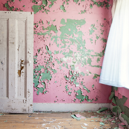 Pink peeling paint exposing green paint underneath